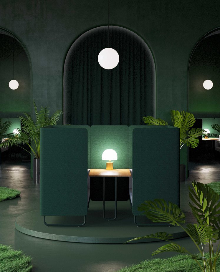 Dark green hospitality booth seating with soft lighting and planting