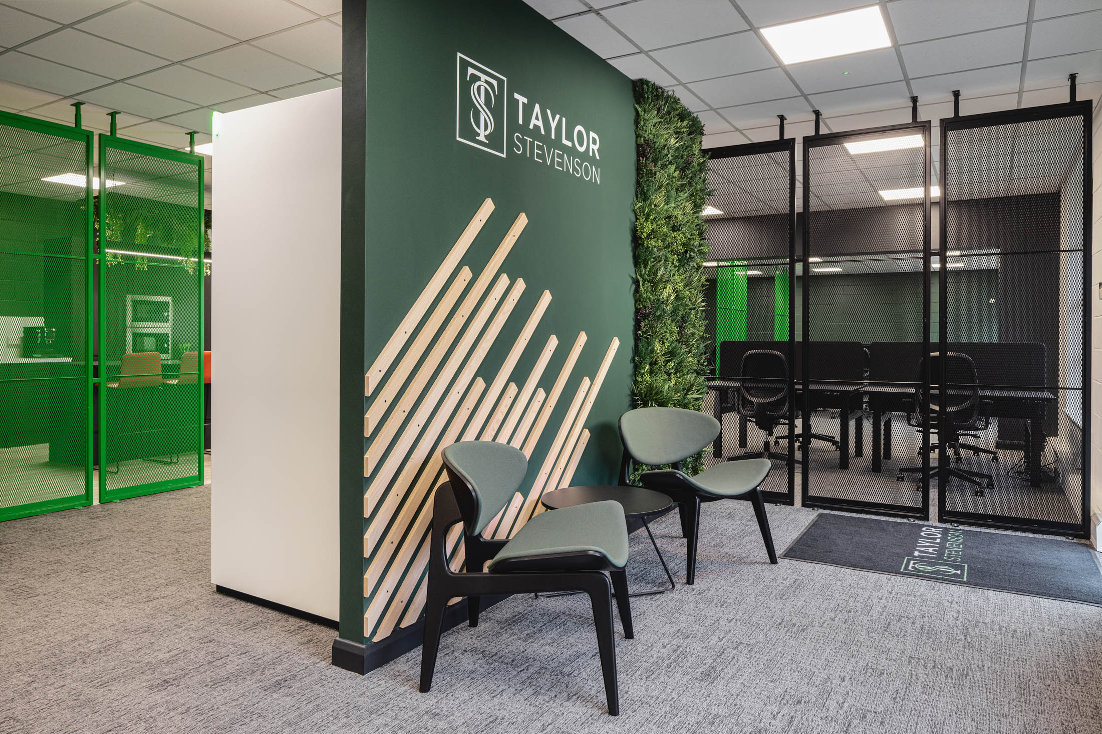 Branded reception area with fabric seating and bespoke mesh panels