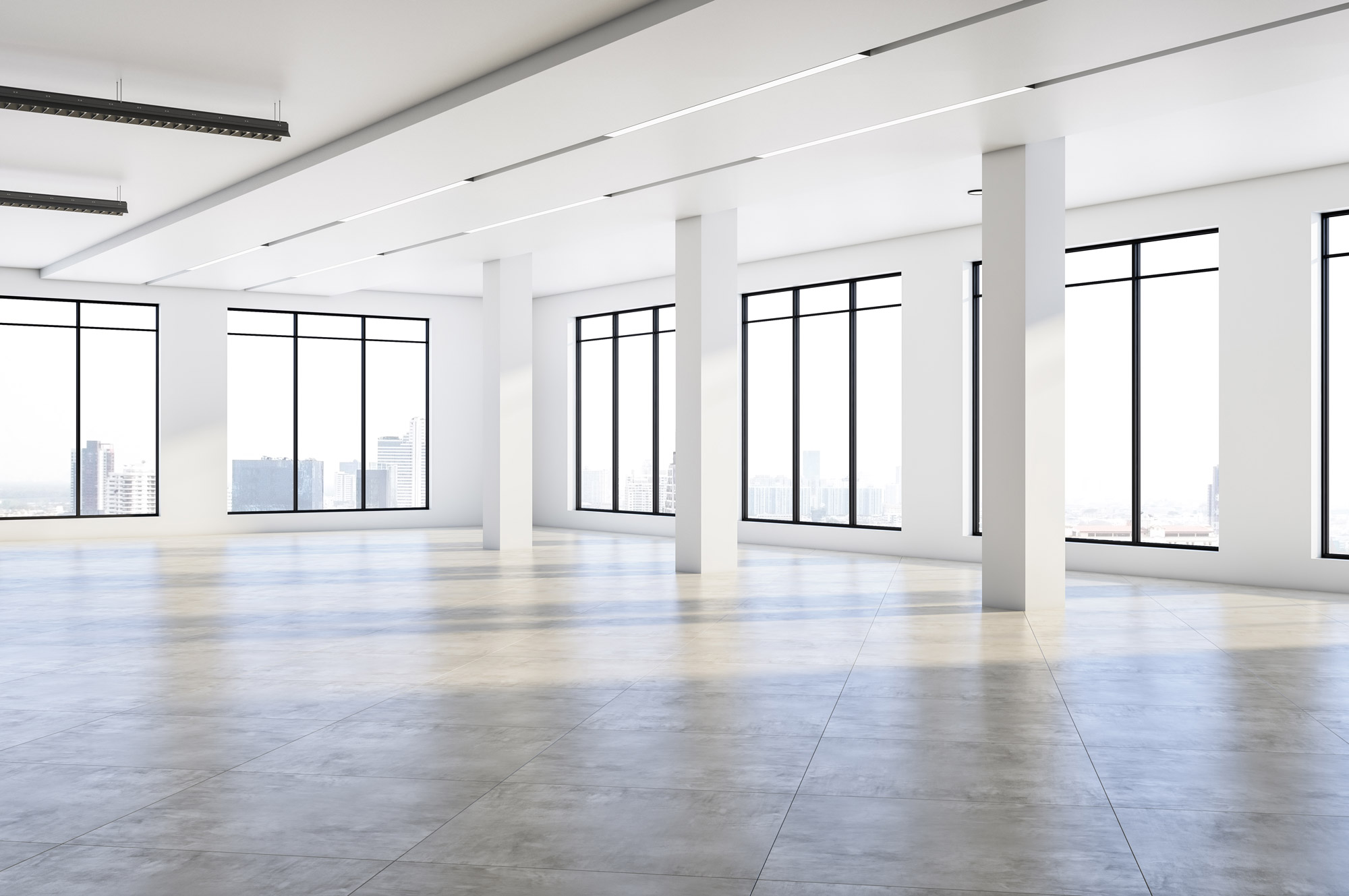 An empty concrete floorplate with columns and full height windows, ready for fit out
